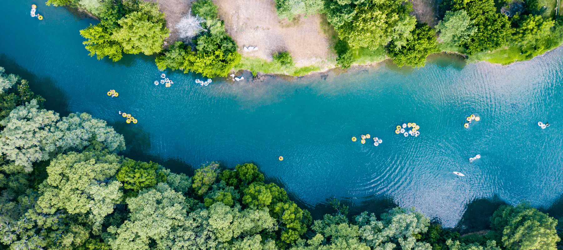 aerial view of the new braunfels river with people floating in tubes